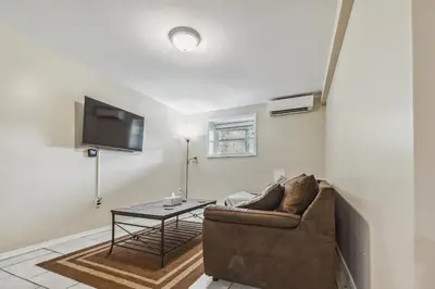 a living room with a couch and a table at Poconos Chalet newly renovated, great location home in Tobyhanna