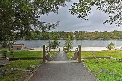 a bridge over a lake with a body of water at Poconos Chalet newly renovated, great location home in Tobyhanna