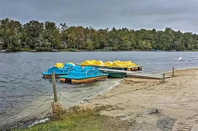 a group of boats parked on the shore of a lake at Poconos Chalet newly renovated, great location home in Tobyhanna