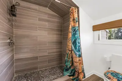 a shower in a bathroom with a shower curtain at Beach house - 3BR Beach Gem - 30ft to Sand & Walk to Amusement Park in Keansburg