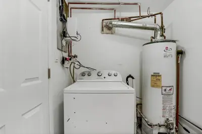 a washer and dryer in a small room with aperature at Beach house - 3BR Beach Gem - 30ft to Sand & Walk to Amusement Park in Keansburg