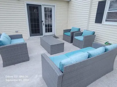 a patio with two chairs and blue pillows at Beach house - 3BR Beach Gem - 30ft to Sand & Walk to Amusement Park in Keansburg