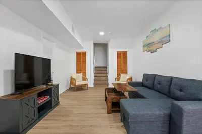 a living room with a couch and a tv at Beach house - 3BR Beach Gem - 30ft to Sand & Walk to Amusement Park in Keansburg