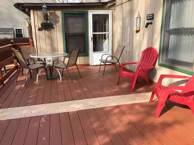 a patio with chairs and a table on a deck at Tranquil Getaway in the Pocono Mountains in Thornhurst