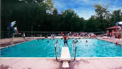 a group of people in a swimming pool at Tranquil Getaway in the Pocono Mountains in Thornhurst
