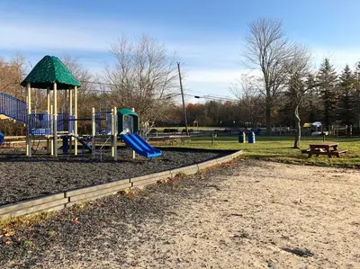 a playground with a slide in a park at Tranquil Getaway in the Pocono Mountains in Thornhurst