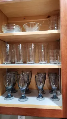 a bunch of glasses sitting on a shelf at Entire townhouse close to Hershey Park in Enola