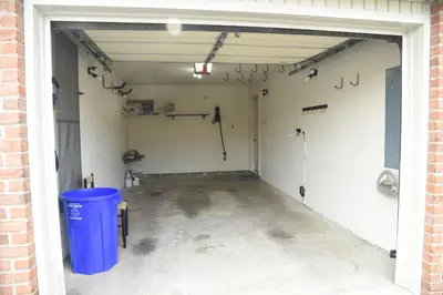 an empty garage with a door open and a trash can at Entire townhouse close to Hershey Park in Enola