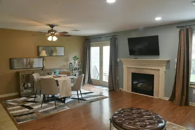 a living room with a table and a fireplace at Entire townhouse close to Hershey Park in Enola