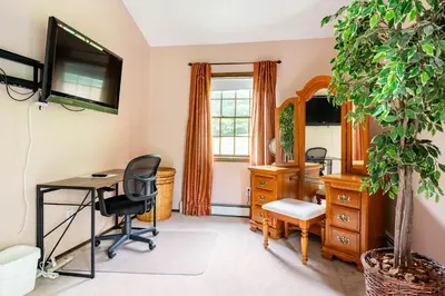 a home office with a desk and a mirror at Bethel Woods Retreat - wPool, Hot Tub & Arcade! in Mongaup Valley