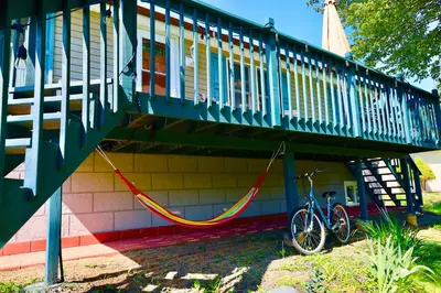 a bike is chained to a house with a staircase at Farm Country House with Pool and Huge Property in Blakeslee