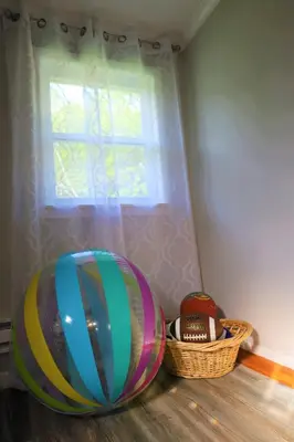 a room with a window and a large ball and a basket at Farm Country House with Pool and Huge Property in Blakeslee