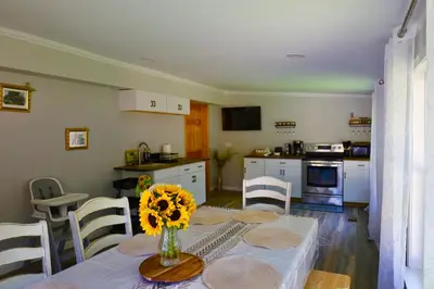 a kitchen with a table with a vase of flowers on it at Farm Country House with Pool and Huge Property in Blakeslee