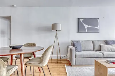 a living room with a table and a couch at Midtown E 1BR w Gym Doorman nr the 6 NYC-4 in New York