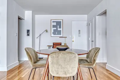 a dining room with a table and chairs at Midtown E 1BR w Gym Doorman nr the 6 NYC-4 in New York