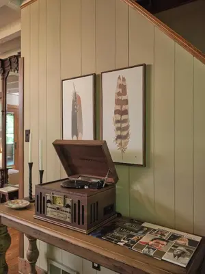 a table with a laptop on top of it at Luxuriously Restored Farm Cabin in Mountainhome