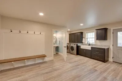 a kitchen with a sink and a washer and dryer at Patio and Yard Newly Built Retreat in Ronks! in Ronks