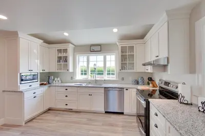a white kitchen with white cabinets and a window at Patio and Yard Newly Built Retreat in Ronks! in Ronks