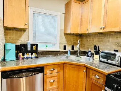 a kitchen with wooden cabinets and a sink at Campu’s House - HOME SWEET HOME in Cherry Hill in Cherry Hill