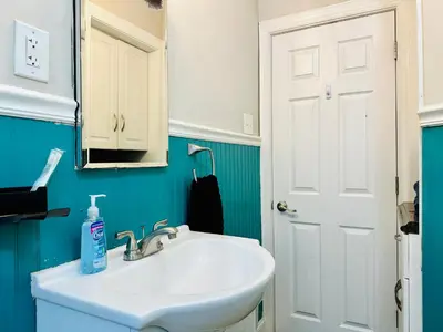 a bathroom with a white sink and a mirror at Campu’s House - HOME SWEET HOME in Cherry Hill in Cherry Hill