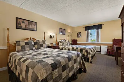 a hotel room with two beds and a window at Country Living Inn in Lancaster