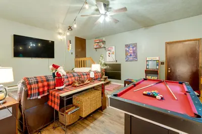 a living room with a pool table and a couch at 1 Mi to Gouldsboro State Park Cabin with Deck! in Gouldsboro