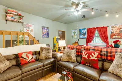 a living room with a brown leather couch at 1 Mi to Gouldsboro State Park Cabin with Deck! in Gouldsboro