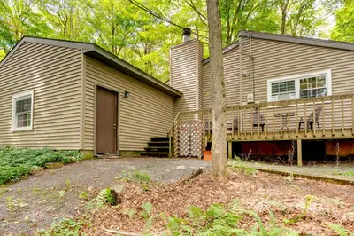 a house with a porch and a deck at 1 Mi to Gouldsboro State Park Cabin with Deck! in Gouldsboro