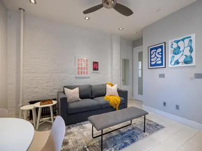 a living room with a couch and a table at Cozy & Convenient Midtown Condo-Hotel! in New York