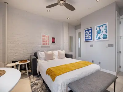 a bedroom with a large bed in a room at Cozy & Convenient Midtown Condo-Hotel! in New York
