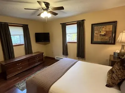 a bedroom with a bed and a ceiling fan at Woodfield Manor - A Sundance Vacations Property in Cresco