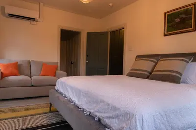 a bedroom with a bed and a couch at Pinetown Bridge Bnb LLC in Leola