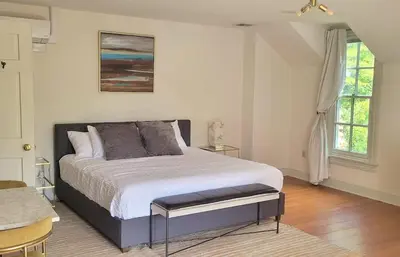 a bedroom with a large bed and a window at Pinetown Bridge Bnb LLC in Leola