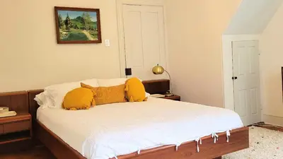 a bedroom with a bed with yellow pillows at Pinetown Bridge Bnb LLC in Leola