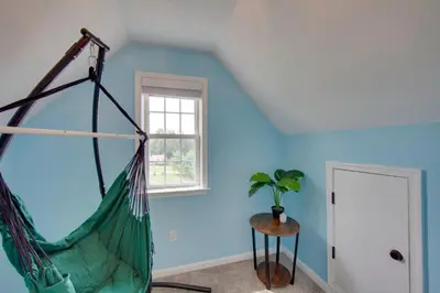 a hammock in a room with blue walls at Game Room and Covered Patio Hummelstown Hideaway in Hummelstown