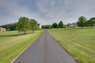 a dirt road in a field with trees and houses at Game Room and Covered Patio Hummelstown Hideaway in Hummelstown