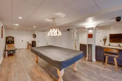 a large room with a bed in the middle of it at Game Room and Covered Patio Hummelstown Hideaway in Hummelstown