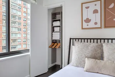 a bedroom with a bed and a window at Gorgeous Midtown W 1BR w Gym nr Times Sq NYC-651 in New York