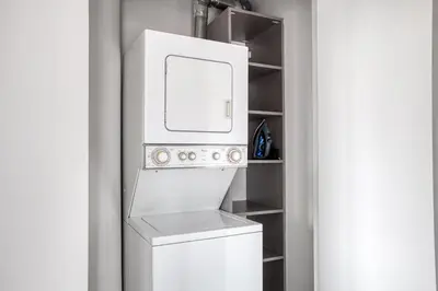a white washer and dryer in a room at Gorgeous Midtown W 1BR w Gym nr Times Sq NYC-651 in New York