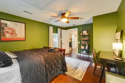 a bedroom with green walls and a bed and a desk at Upper Black Eddy Home with Delaware River Access! in Upper Black Eddy