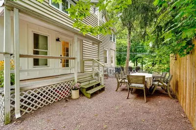 a porch of a house with a table and chairs at Upper Black Eddy Home with Delaware River Access! in Upper Black Eddy