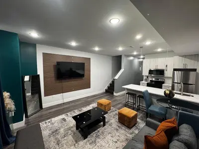 a living room with a couch and a kitchen at Yanne's Place - Philabundance Views in Philadelphia