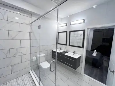 a bathroom with a shower and a toilet and a sink at Yanne's Place - Philabundance Views in Philadelphia
