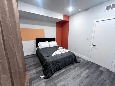 a bedroom with a bed with a black bedspread at Yanne's Place - Philabundance Views in Philadelphia