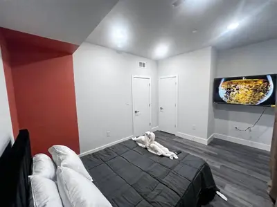 a living room with a bed and a fish tank on the wall at Yanne's Place - Philabundance Views in Philadelphia