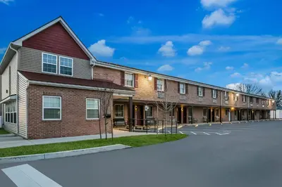 a large brick building with a parking lot at Red Roof Inn Hershey in Hershey