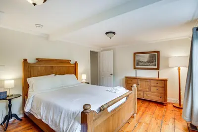 a bedroom with a large bed and a wooden floor at Peaceful Upstate New York Home with Yard and Fire Pit! in Walden