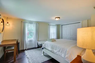 a bedroom with a bed and a desk and a window at Peaceful Upstate New York Home with Yard and Fire Pit! in Walden