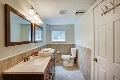 a bathroom with a sink and a toilet and a mirror at Peaceful Upstate New York Home with Yard and Fire Pit! in Walden