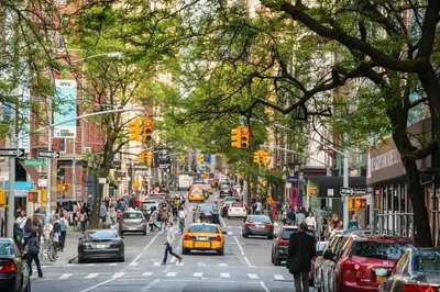 a busy city street with a lot of cars and people at ✪ Large 2 Bedrooms ✪ Queen Beds ✪ Work Stations in New York